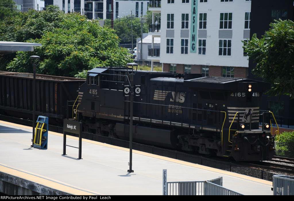 Local cruises west through the station